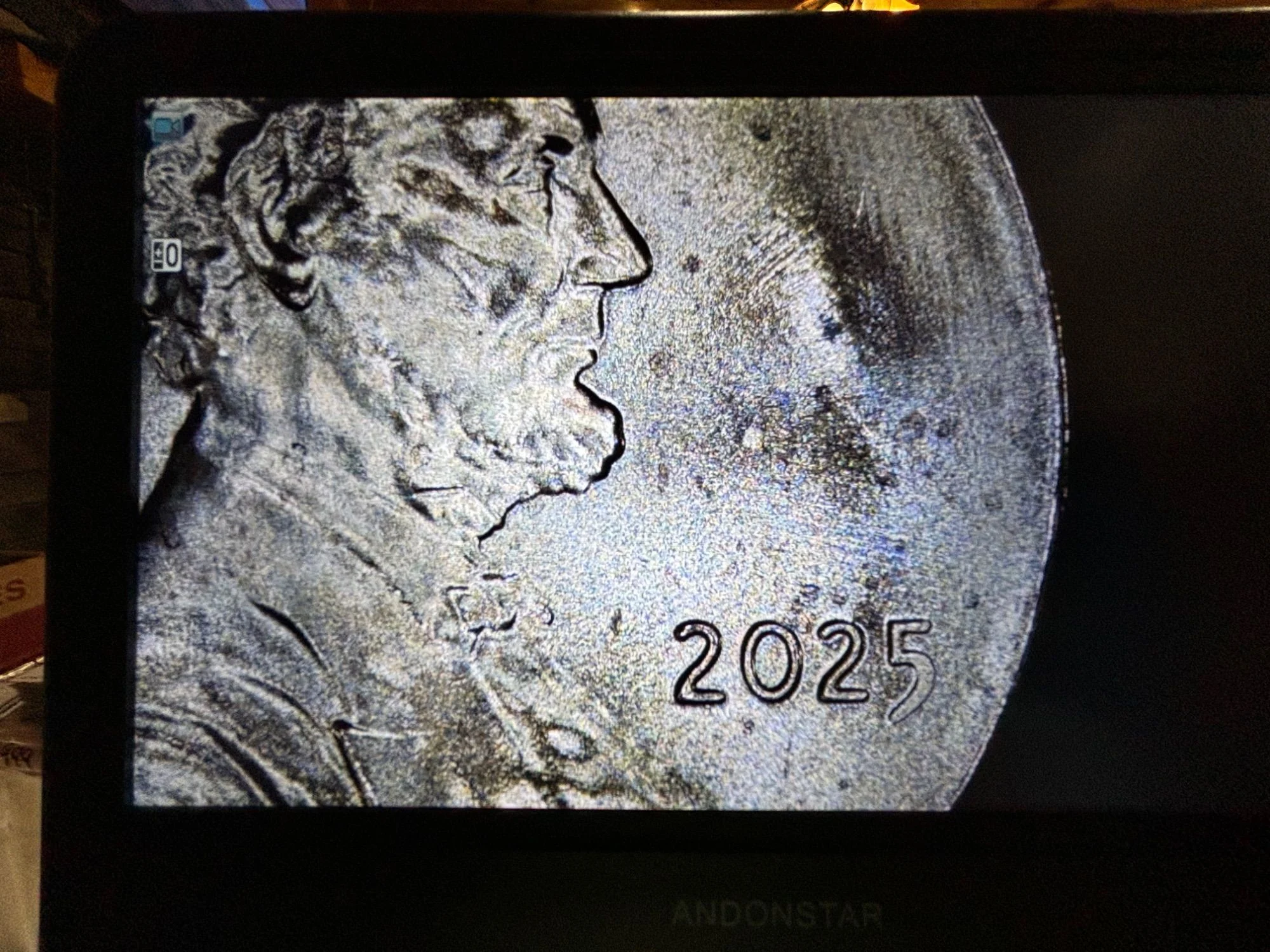 2025 penny struck-through error showing a linear impression from foreign material across the Lincoln portrait